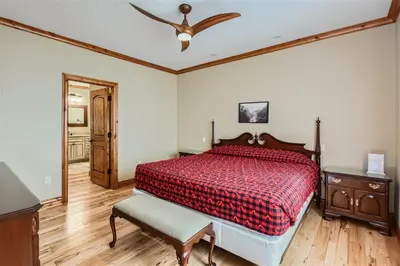 a bedroom with a bed with a red comforter at Rocky Mountain Retreat home in Nederland