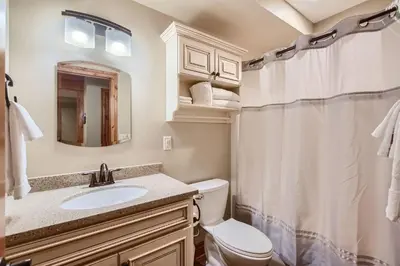 a bathroom with a sink and a toilet and a mirror at Rocky Mountain Retreat home in Nederland