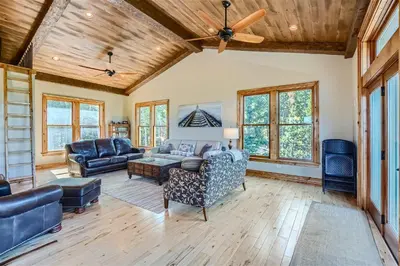 a living room with couches and a ceiling fan at Rocky Mountain Retreat home in Nederland
