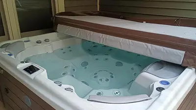 a jacuzzi tub in a room with a bed at Rocky Mountain Retreat home in Nederland