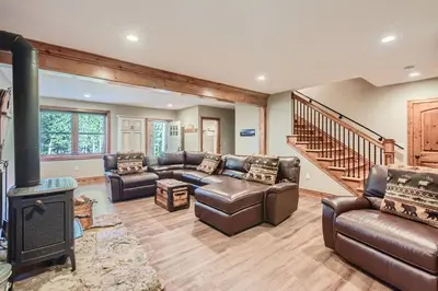 a living room with leather furniture and a fireplace at Rocky Mountain Retreat home in Nederland