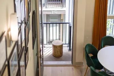 a hallway with a stool and a table and chairs at Roof Deck - MTN View - Hot Tub - Cold Plunge in Silverthorne