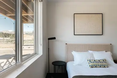 a bedroom with a bed and a window at New Luxe Condo - Hot Tub - Minutes to WP! - Fraser in Fraser