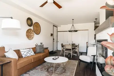 a living room with a couch and a table at New Luxe Condo - Hot Tub - Minutes to WP! - Fraser in Fraser