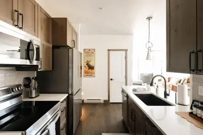 a kitchen with a sink and a counter top at New Luxe Condo - Hot Tub - Minutes to WP! - Fraser in Fraser