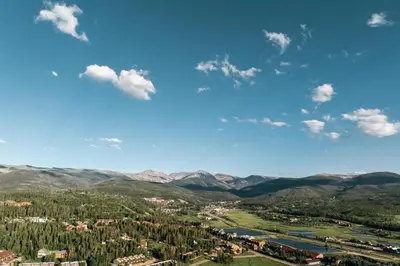 a view of a valley with mountains and a town at New Luxe Condo - Hot Tub - Minutes to WP! - Fraser in Fraser
