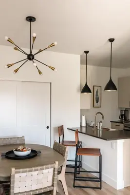 a kitchen and dining room with a table and chairs at New Modern Charm - Hot Tub - Deck Views! - Fraser in Fraser