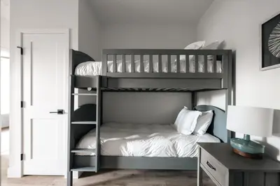 a bedroom with two bunk beds and a desk at New Modern Charm - Hot Tub - Deck Views! - Fraser in Fraser