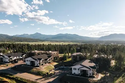 an aerial view of a home with mountains in the background at New Modern Charm - Hot Tub - Deck Views! - Fraser in Fraser