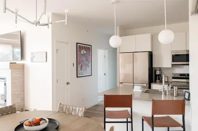 a kitchen and dining room with a table and chairs at Chic Condo - Near Town and Trails - Hot Tub - Deck in Fraser