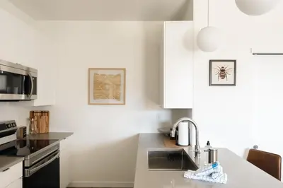 a kitchen with white cabinets and a sink at New MTN Retreat - Hot Tub - Deck Views - Fraser in Fraser