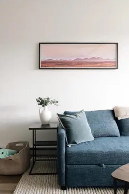 a blue couch in a living room with a picture on the wall at New MTN Retreat - Hot Tub - Deck Views - Fraser in Fraser