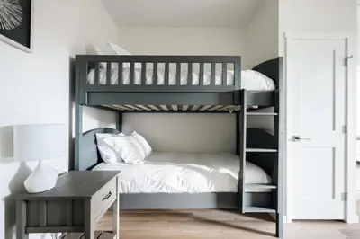 a black bunk bed in a room with a desk at New MTN Retreat - Hot Tub - Deck Views - Fraser in Fraser