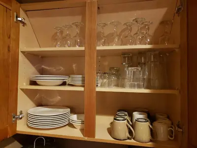 a cupboard filled with glasses and plates and dishes at 2 BR, 2 BA Mountain View Family Friendly Condo BCA-45499 in Keystone