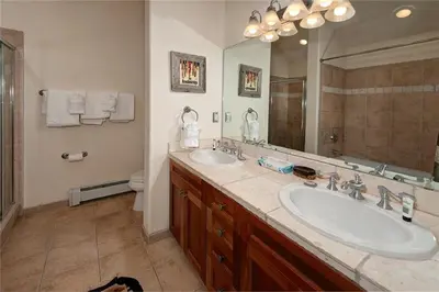 a bathroom with two sinks and a large mirror at 2 BR, 2 BA Mountain View Family Friendly Condo BCA-45499 in Keystone