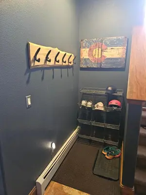 a room with a wall with a door with shoes on it at 2 BR, 2 BA Mountain View Family Friendly Condo BCA-45499 in Keystone