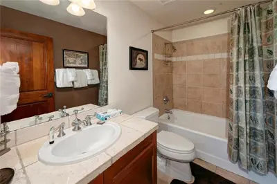 a bathroom with a sink and a toilet and a tub at 2 BR, 2 BA Mountain View Family Friendly Condo BCA-45499 in Keystone
