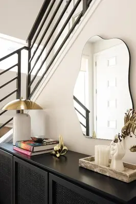 a mirror on a black dresser in a room with stairs at Vogue Posh Pad - Center of LoHi - Large Roof Deck in Denver
