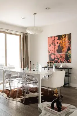 a dining room with a white table and chairs at Vogue Posh Pad - Center of LoHi - Large Roof Deck in Denver
