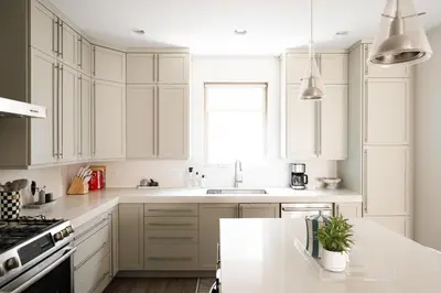 a white kitchen with white cabinets and a sink at Vogue Posh Pad - Center of LoHi - Large Roof Deck in Denver