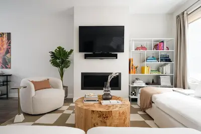 a living room with a couch and a table and a tv at Vogue Posh Pad - Center of LoHi - Large Roof Deck in Denver