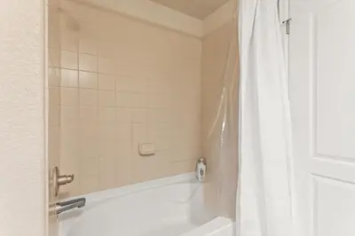 a bathroom with a bath tub with a shower curtain at Aspen Meadows Condo in the beautiful area of Granby Ranch! in Granby