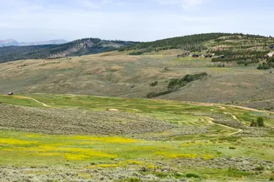 a golf course in the middle of a hill at Aspen Meadows Condo in the beautiful area of Granby Ranch! in Granby