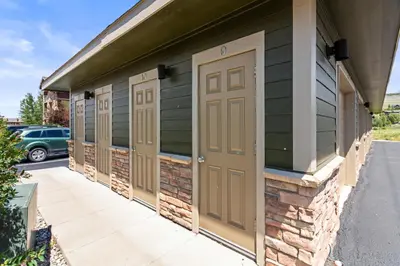 a row of doors on the side of a building at Aspen Meadows Condo in the beautiful area of Granby Ranch! in Granby