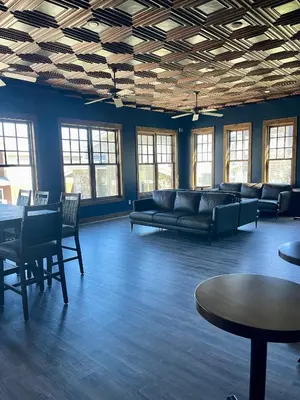 a large room with a couch and tables and windows at Aspen Meadows Condo in the beautiful area of Granby Ranch! in Granby