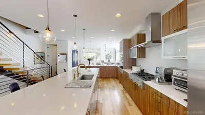 a kitchen with white counter tops and wooden cabinets at Luxurious, Modern Townhome 5 minute Walk from Cherry Creek North in Denver