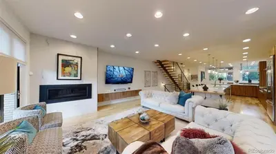 a living room with white furniture and a fireplace at Luxurious, Modern Townhome 5 minute Walk from Cherry Creek North in Denver