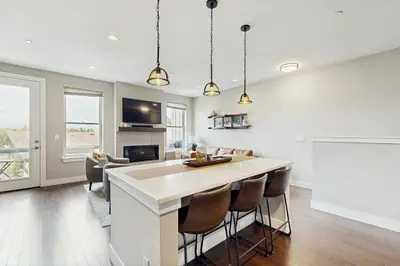 a kitchen with a bar and a living room at Serene Escape in Fraser in Fraser