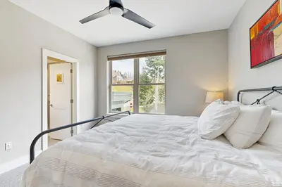 a bedroom with a bed with a ceiling fan at Serene Escape in Fraser in Fraser