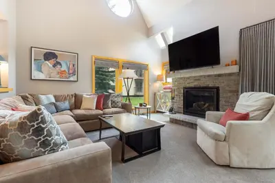 a living room with a couch and a fireplace at 13 Liftside townhouse in Keystone