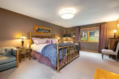 a bedroom with a bed and a chair and a window at 13 Liftside townhouse in Keystone