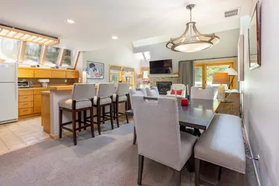a kitchen and dining room with a table and chairs at 13 Liftside townhouse in Keystone