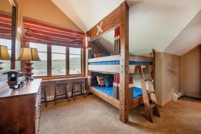 a bedroom with two bunk beds in a house at Select Unit 1710 - 2BR - Zephyr Mountain Lodge condo in Winter Park