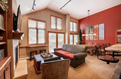 a living room with a couch and a table at Select Unit 1710 - 2BR - Zephyr Mountain Lodge condo in Winter Park
