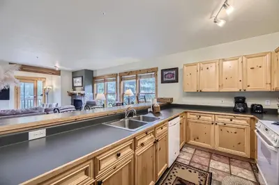 a kitchen with wooden cabinets and a sink at 2652 Tenderfoot Lodge condo in Keystone