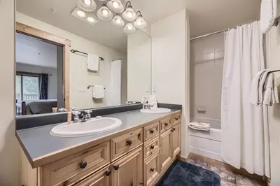 a bathroom with two sinks and a large mirror at 2652 Tenderfoot Lodge condo in Keystone