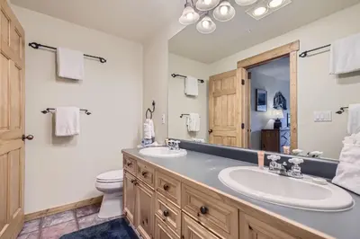 a bathroom with two sinks and a toilet at 2652 Tenderfoot Lodge condo in Keystone