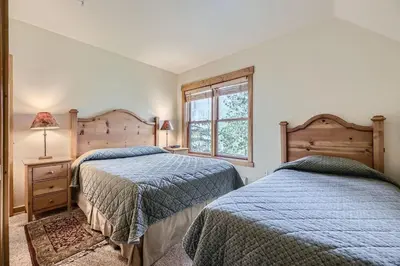 a bedroom with two beds and a window at 2652 Tenderfoot Lodge condo in Keystone