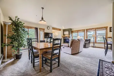 a dining room and living room with a table and chairs at 2652 Tenderfoot Lodge condo in Keystone