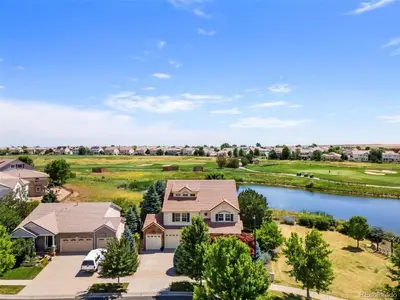 an aerial view of a house with a lake at Denver Retreat Home with Stunning Lake, Mountain Views and Luxury Amenities in Denver