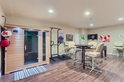 a salon with a table and chairs in a room at Denver Retreat Home with Stunning Lake, Mountain Views and Luxury Amenities in Denver