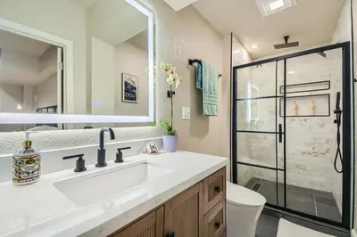 a bathroom with a sink and a shower at Denver Retreat Home with Stunning Lake, Mountain Views and Luxury Amenities in Denver
