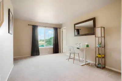 a room with a table and a mirror and a window at Denver Retreat Home with Stunning Lake, Mountain Views and Luxury Amenities in Denver