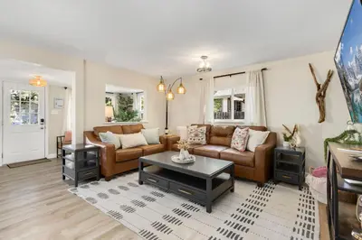a living room with a couch and a table at Downtown Windsor Home with Hot Tub and Pool Table in Windsor