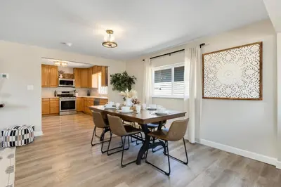 a kitchen and dining room with a table and chairs at Downtown Windsor Home with Hot Tub and Pool Table in Windsor