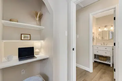 a bathroom with a sink and a laptop on a counter at Downtown Windsor Home with Hot Tub and Pool Table in Windsor